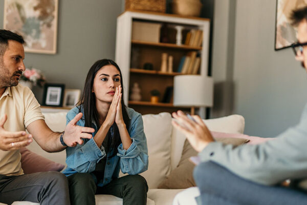 Young couple arguing during therapy session