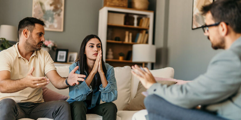 Young couple arguing during therapy session