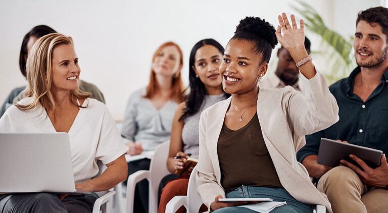 Young woman raising hand during discussion