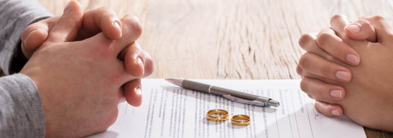 Couple's Hand On Divorce Agreement