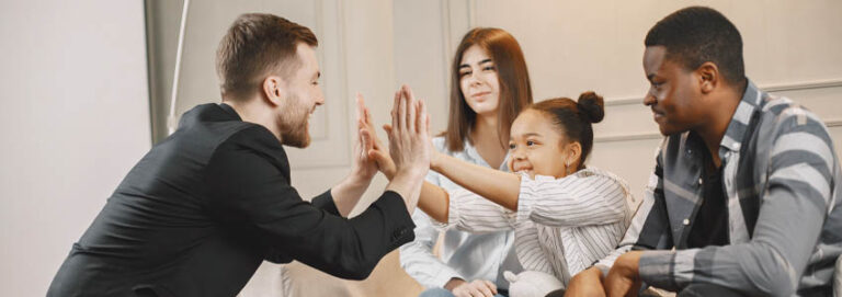 Therapist clapping hands with little girl at family consultation clapping hands with little girl at family consultation