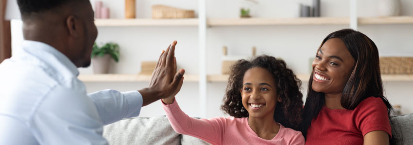 Positive black mother and daughter teenager at the appointment with male psychologist