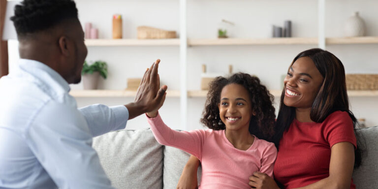 Positive black mother and daughter teenager at the appointment with male psychologist