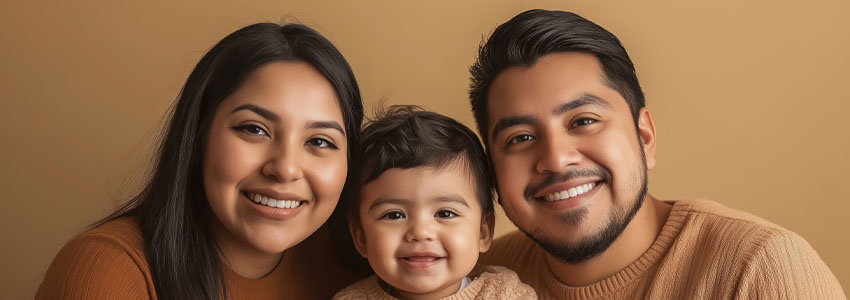 Portrait of a cheerful latino family smiling, wearing matching sweaters