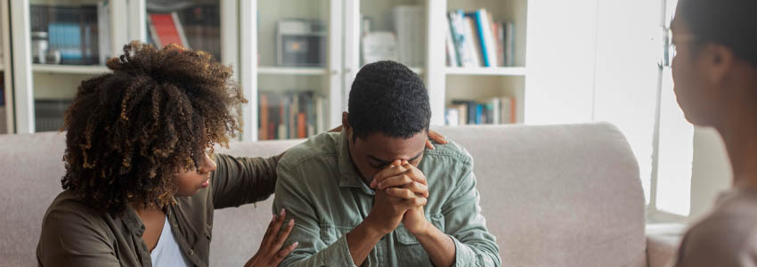 Woman comforting spouse during therapy session