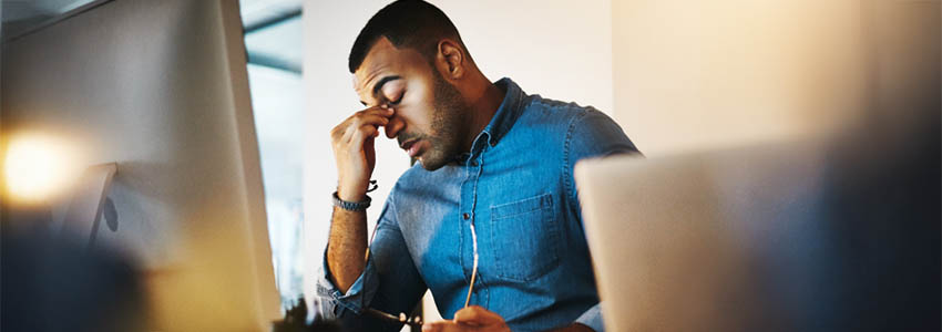 Headache, tired and businessman working in the office with eye strain from the computer or technology.