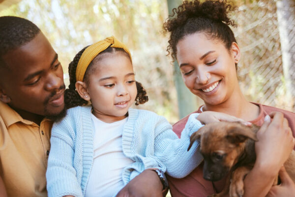 Happy family, animal shelter and dog with girl and parents bond
