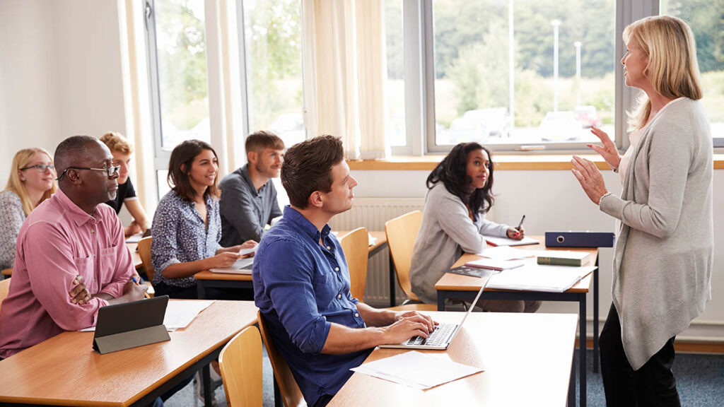 Female Tutor Teaching Class Of Mature Students