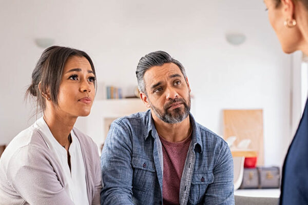 Worried couple meeting therapist