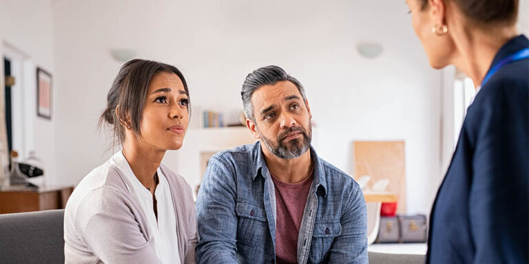 Worried couple meeting therapist