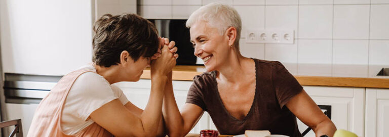 Mature same sex happy couple having breakfast together