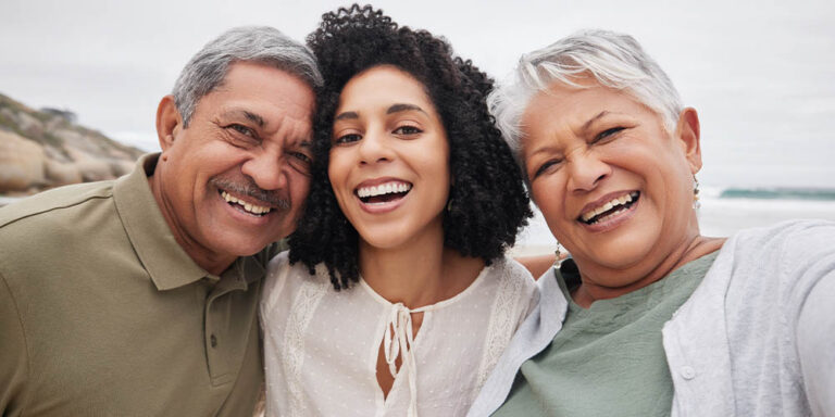 Woman and parents taking photo at beach