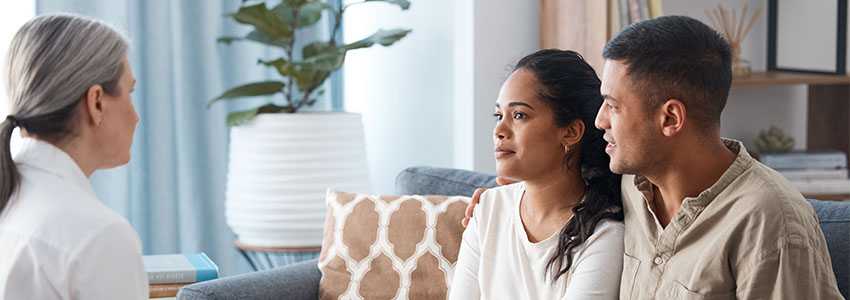 Couple on sofa, therapist and counselling for support, love and help with relationship advice together