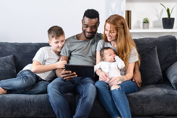 Family sitting on couch together
