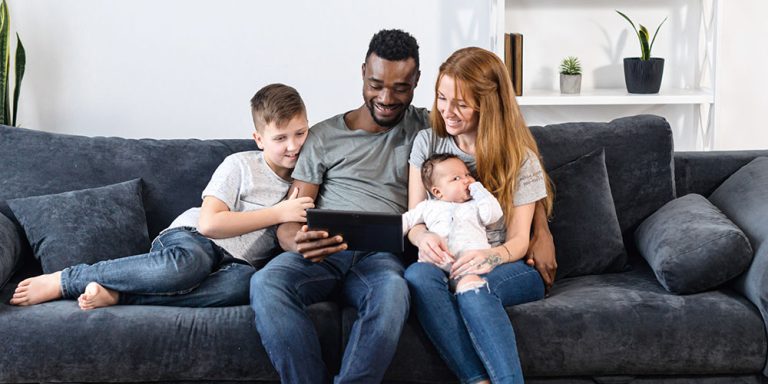 Family sitting on couch together