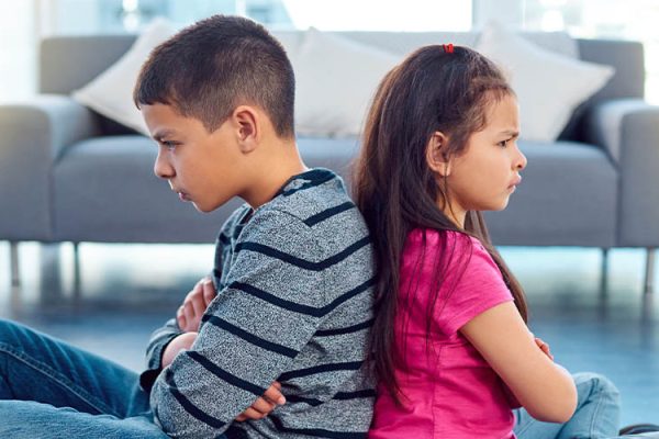 Brother and sister mad and facing away from each other