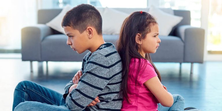 Brother and sister mad and facing away from each other