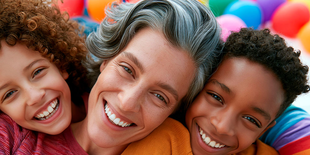 Smiling caucasian mother with multicultural children showing love, inclusion and joyful family connection