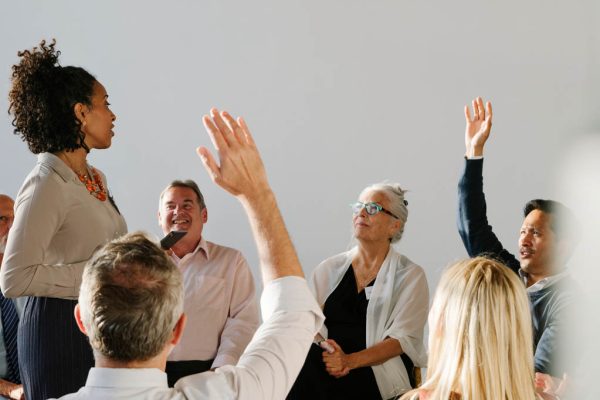 Teacher speaking to group of people sitting in circle