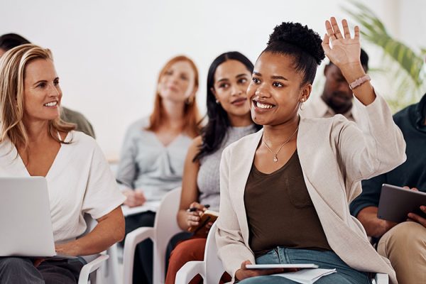Young woman raising hand during discussion